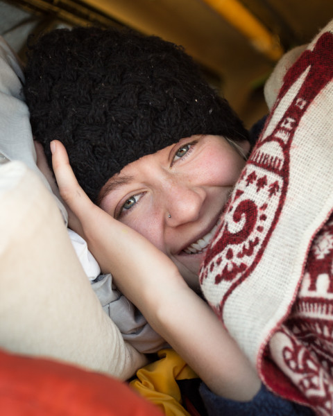 Young woman bundled up after camping on a cold October night outside Yellowstone National Park